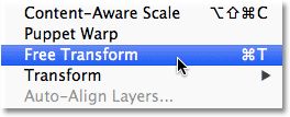 Choosing the Free Transform command from the Edit menu in Photoshop. Image © 2012 Photoshop Essentials.com