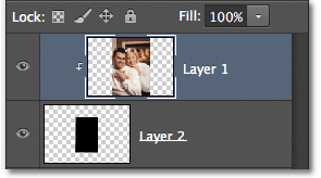 Panel Layers menampilkan Layer 1 dijepit ke lapisan di bawahnya. Image © 2012 Photoshop Essentials.com