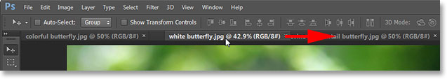 Dragging a tab to the right to change the order of the images. Image © 2013 Photoshop Essentials.com