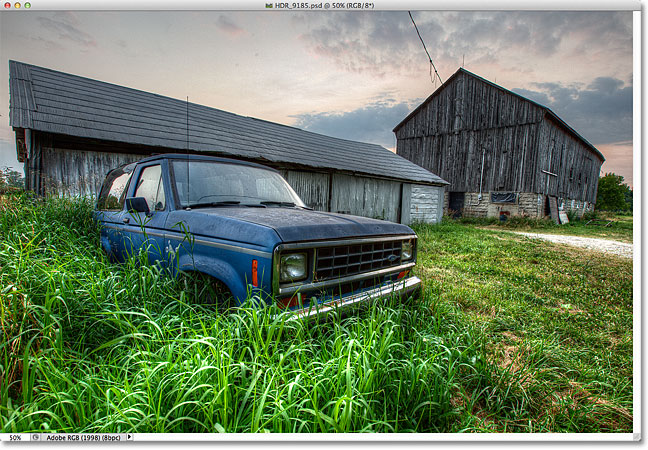 An HDR photo of an old truck in tall grass in front of a weathered barn. Image © 2012 Steve Patterson