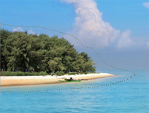 Menggambar garis seleksi di sekitar pulau dengan Lasso Tool. Image © 2012 Photoshop Essentials.com