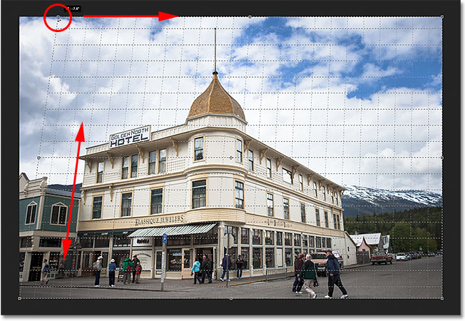 Dragging the top left crop handle to adjust the perspective grid. Image © 2012 Steve Patterson