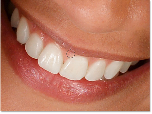 Cleaning up the areas around the teeth by painting with black on the layer mask.
