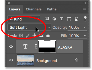 Changing the Type layer's blend mode to Soft Light. Image © 2016 Photoshop Essentials.com