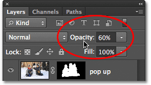 Menurunkan opacity layer. Image © 2012 Photoshop Essentials.com.