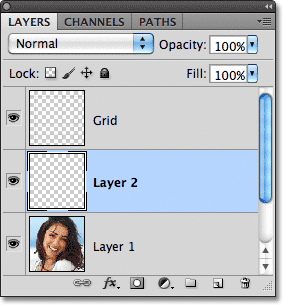 Sebuah layer baru ditambahkan di bawah lapisan Grid. Gambar © 2011 Photoshop Essentials.com.