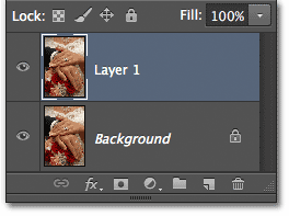 Panel Layers menampilkan Layer 1 di atas layer Background. Image © 2012 Photoshop Essentials.com