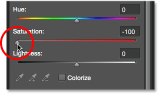 Dragging the Saturation slider to the left to remove color from the squares.  Image © 2014 Photoshop Essentials.com.