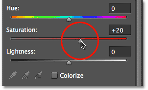 Menyeret slider Saturation di panel Properties. Image © 2012 Photoshop Essentials.com