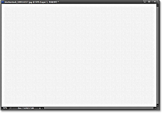 The layer is filled with the canvas texture. Image © 2013 Photoshop Essentials.com