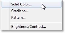 Selecting a Solid Color fill layer in the Layers panel. Image © 2013 Photoshop Essentials.com