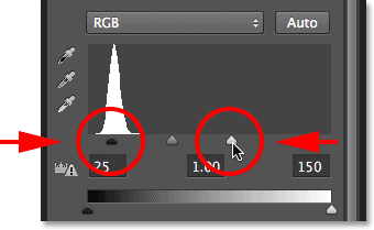 Dragging the Levels black point and white point sliders. Image © 2013 Photoshop Essentials.com