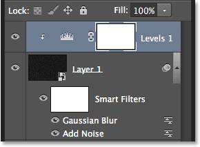 Selecting the Use Previous Layer to Create Clipping Mask option. Image © 2013 Photoshop Essentials.com