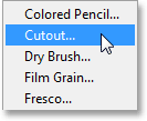 Memilih filter Cutout dari menu Filter. Image © 2013 Photoshop Essentials.com