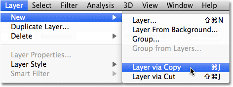 Memilih New Layer via Copy dari menu Layer dalam Photoshop. Image © 2010 Photoshop Essentials.com.