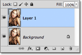 A copy of the Background layer appears above the original in the Layers panel. Image © 2011 Photoshop Essentials.