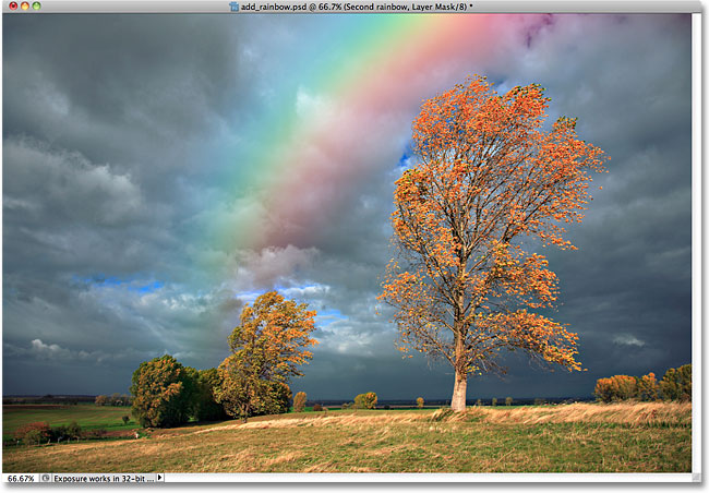 The layer mask has been applied to the second rainbow. Image © 2010 Photoshop Essentials.com