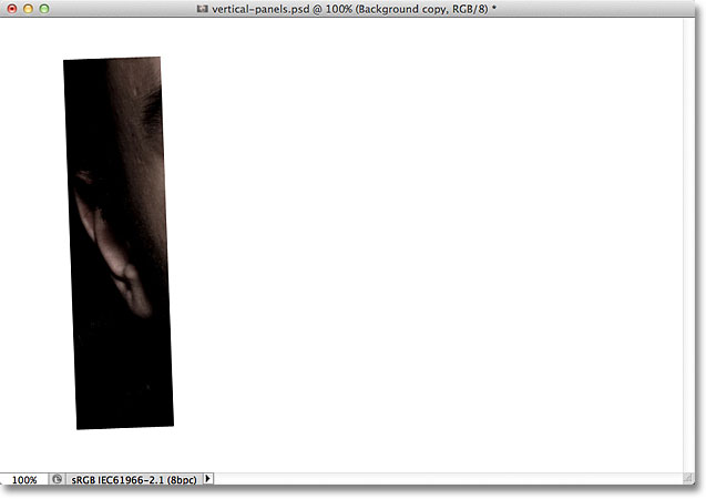 The image on the Background copy layer is now clipped to the vertical panel shape below it. Image © 2011 Photoshop Essentials.com.