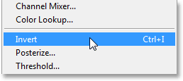 Selecting the Invert command from under the Image menu. Image © 2013 Photoshop Essentials.com