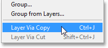 Selecting the New Layer via Copy command under the Layer menu. Image © 2013 Photoshop Essentials.com