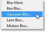 Memilih Gaussian Blur filter dari bawah menu Filter. Image © 2013 Photoshop Essentials.com