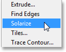 Memilih filter Solarisasi dari bawah menu Filter. Image © 2013 Photoshop Essentials.com