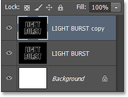 Panel Layers menunjukkan salinan layer teks. Image © 2013 Photoshop Essentials.com