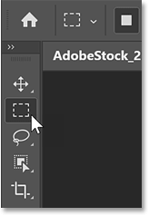 Selecting the Rectangular Marquee Tool from Photoshop's toolbar.