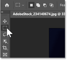 Selecting the Rectangular Marquee Tool from Photoshop's toolbar.