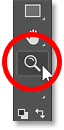 Selecting Photoshop's Zoom Tool from the toolbar.