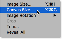 Selecting the Canvas Size command from under the Image menu in Photoshop.