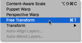 Selecting the Free Transform command from under the Edit menu in Photoshop.