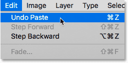 Choosing the Undo Paste command from under the Edit menu in Photoshop.