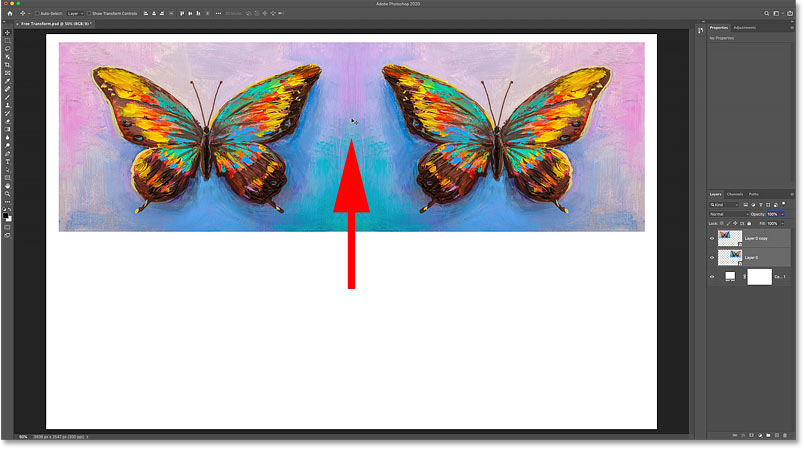 Dragging both copies of the image into the upper half of the canvas in Photoshop