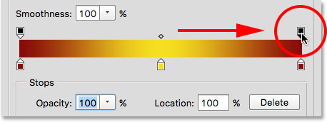 Dragging the transparency stop from the middle to the right of the gradient. Image © 2015 Steve Patterson, Photoshop Essentials.com