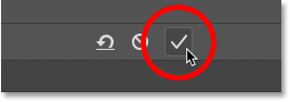 Clicking the checkmark to crop the image in Photoshop