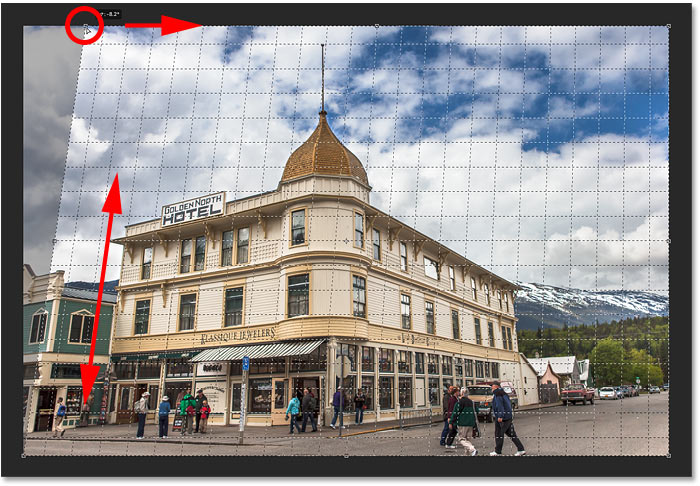 Correcting perspective by matching the grid line with the left side of the building in Photoshop