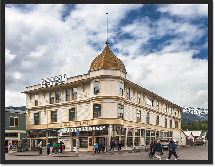 The building is no longer leaning backwards after correcting the perspective with the Perspective Crop Tool in Photoshop