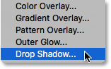 Selezionando Drop Shadow dalla lista degli stili di livello. Image © 2016 Photoshop Essentials.com