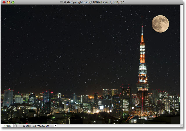 A photo of a moon over the city at night. 