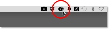 The Creative Cloud icon in the notification area of the taskbar in Windows.