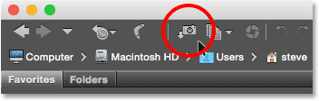 Clicking the Get Photos from Camera icon in the toolbar in Adobe Bridge.