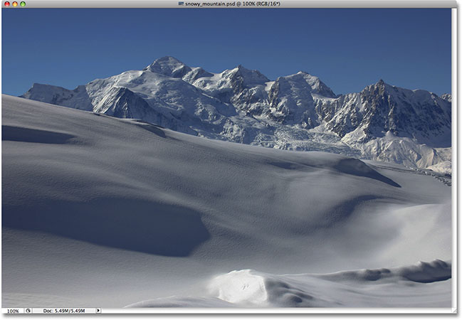 Snow covered mountains photo. Image licensed from iStockphoto by Photoshop Essentials.com.