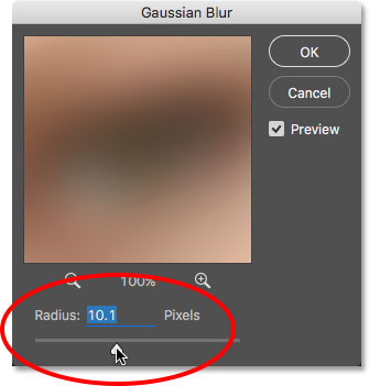 Increasing the Radius value in the Gaussian Blur dialog box. Image © 2016 Photoshop Essentials.com