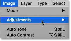 Going to the Image menu and choosing Adjustments in Photoshop's Menu Bar