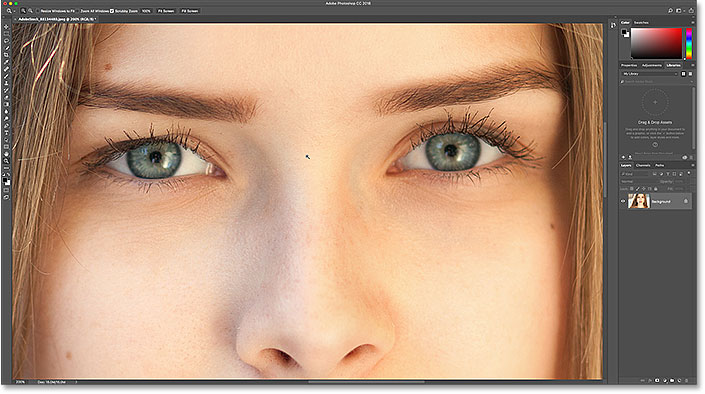 Zooming in on the eyes with the Zoom Tool in Photoshop.