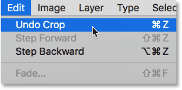 Selecting the Undo Crop command from under the Edit menu. Image © 2016 Photoshop Essentials.com