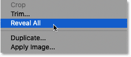 Choosing the Reveal All command from the Image menu in Photoshop