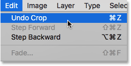 Choosing the Undo Crop command from under the Edit menu. Image © 2016 Steve Patterson, Photoshop Essentials.com