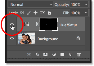 Clicking the Hue/Saturation adjustment layer's visibility icon in the Layers panel.